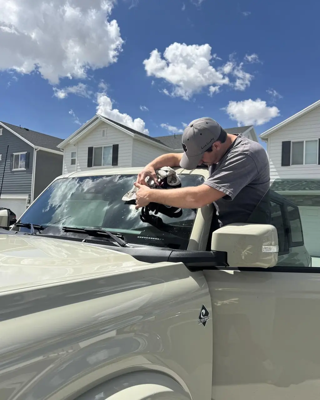 Mobile windshield repair technician working beside a RapidChip service van in Utah