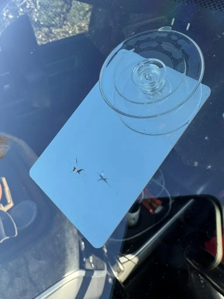 Close-up of a windshield rock chip before mobile repair in Utah